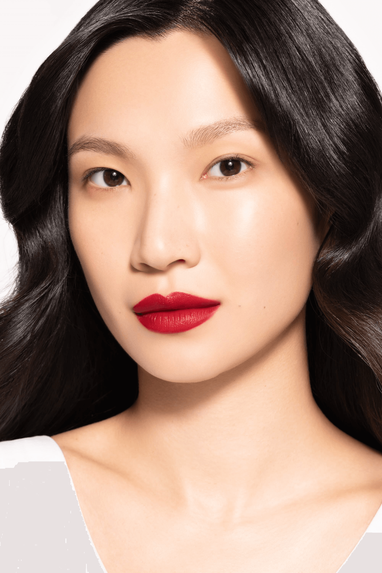 Model showcasing ICD Makeup Butter Lip Tint in a vibrant red matte finish, highlighting lasting color and hydration.