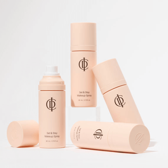 RIMAN ICD Set & Stay Makeup Spray bottles arranged on a neutral background, showcasing makeup setting mist.