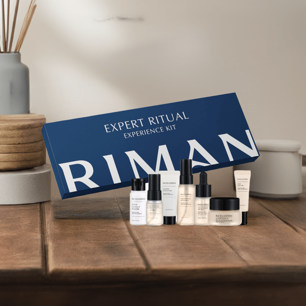 Riman Expert Ritual Experience Kit with 7 travel-size skincare products in elegant gift box on wooden table.
