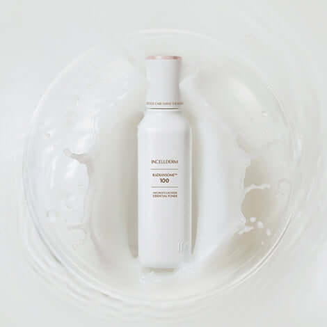 RADIANSOME 100 Microfluidizer Essential Toner in white bottle on a soft cream background, ideal for skin toning and anti-aging.