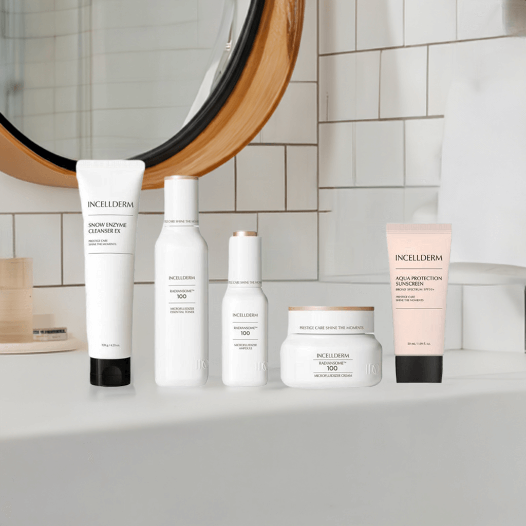 INCELLDERM skincare products arranged on a vanity, featuring cleanser, essence, serum, cream, and sunscreen.