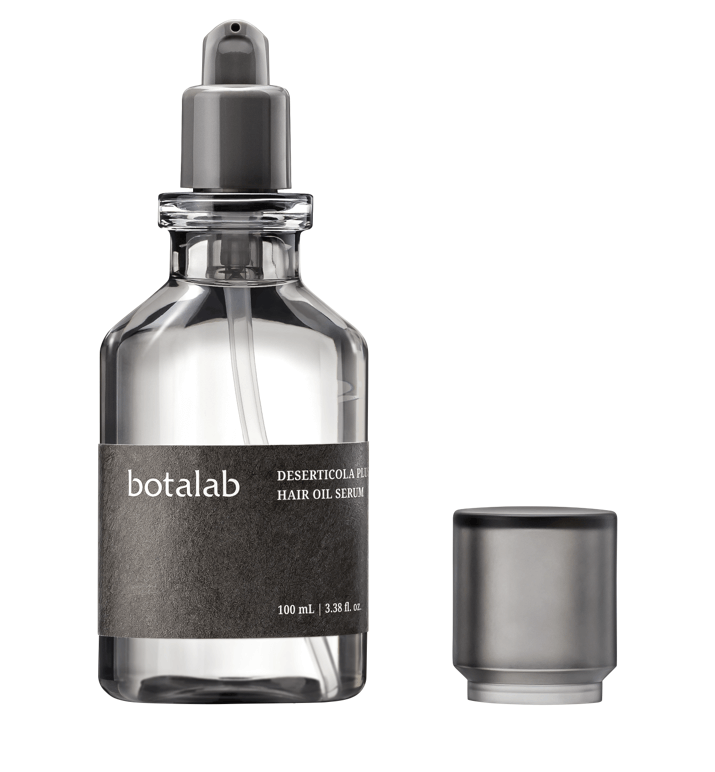 Riman Botalab Deserticola Plus Hair Oil Serum in elegant glass bottle with dropper, ideal for moisturizing and repairing hair.