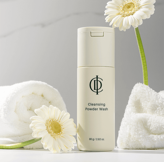Riman ICD Cleansing Powder Wash with flowers and towels, designed to exfoliate and brighten dull skin.