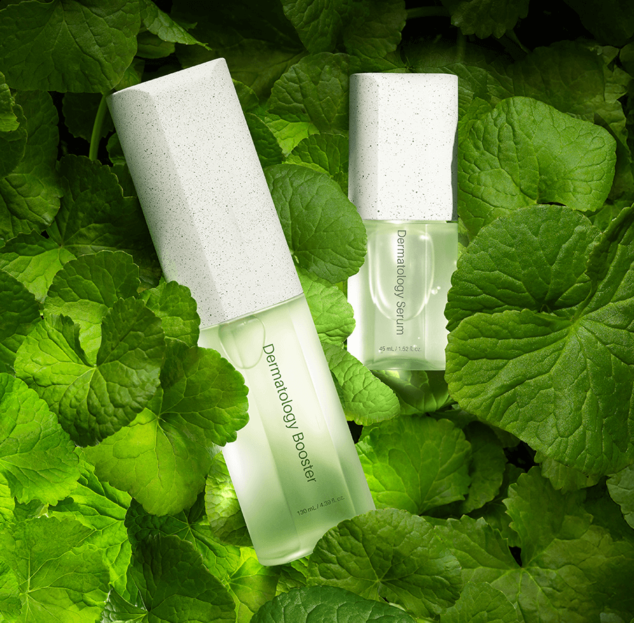 Riman ICD Dermatology booster and serum set surrounded by lush green leaves for deep hydration and skin radiance.