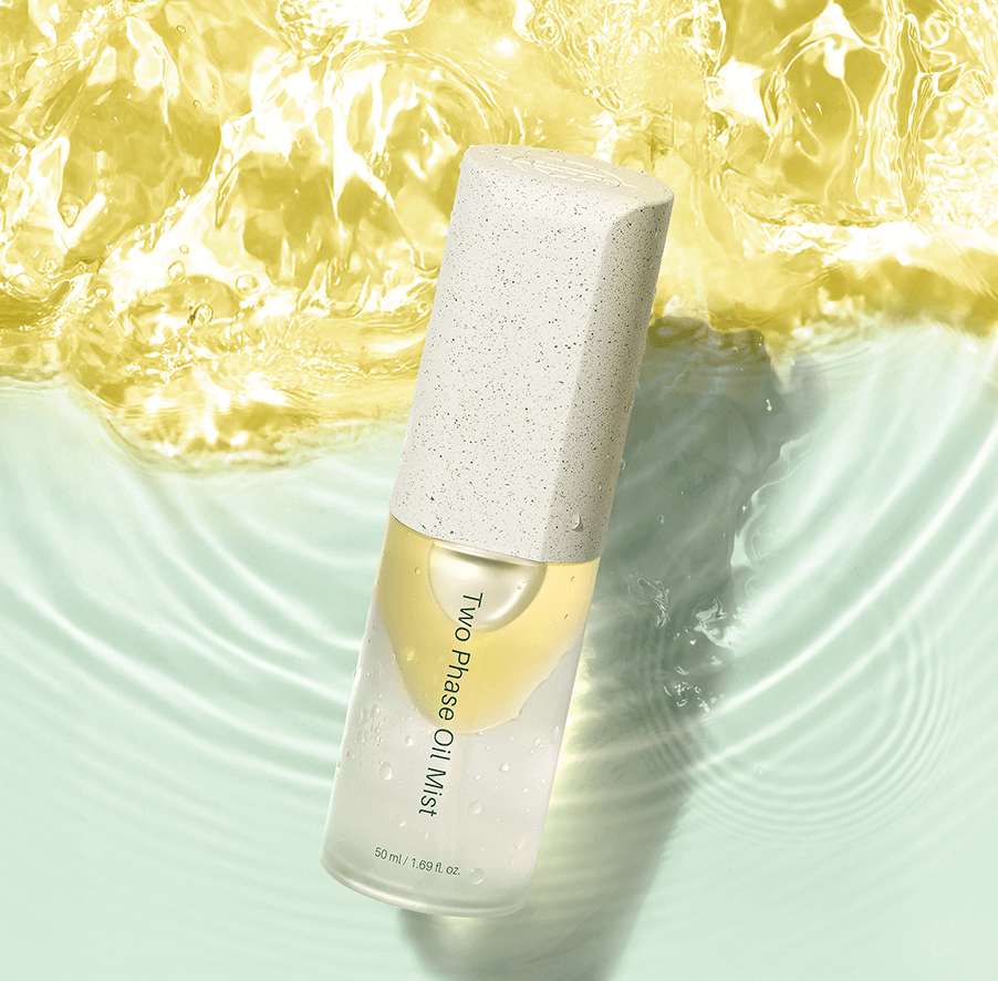Riman Two Phase Oil Mist bottle on a watery surface, showcasing bright, dewy skin benefits from hydrating ingredients.