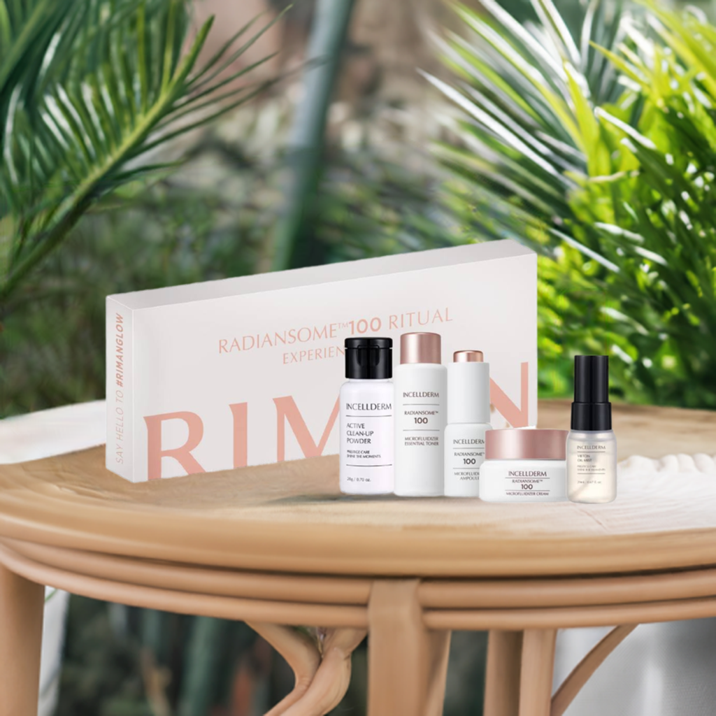 "Riman Radiansome 100 Ritual Experience Kit on a wooden table, featuring a complete skincare set for radiant, youthful skin."