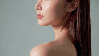 Close-up profile of a woman with glowing skin and long hair, showcasing healthy beauty and radiance.