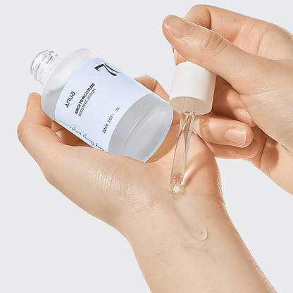 Anua Birch 70 Moisture Boosting Serum being applied to the skin with a dropper for hydration.