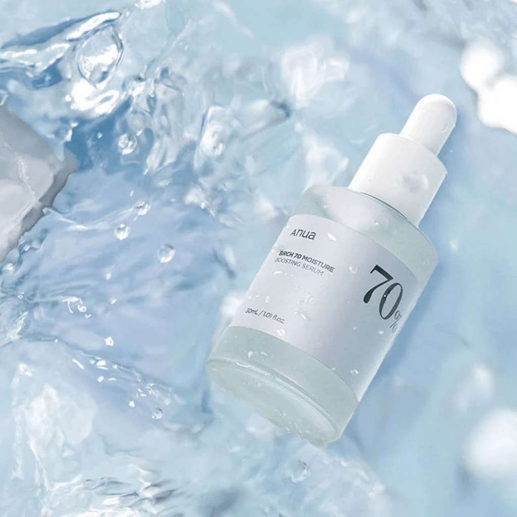 Anua Birch 70 Moisture Boosting Serum in a splash of water, showcasing the hydrating product.