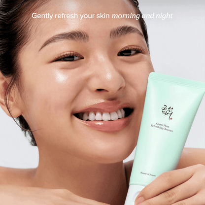 Beauty of Joseon Green Plum Refreshing Cleanser in the hands of a smiling person, promoting gentle skin refreshment.