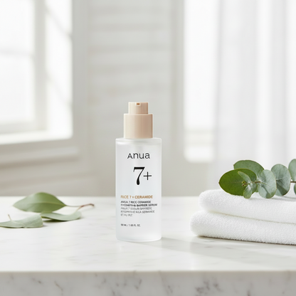Anua 7 Rice Ceramide Hydrating Barrier Serum in a clear bottle on a light background with serum texture.