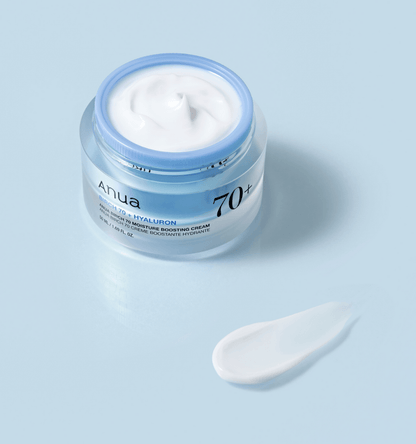 Anua Birch 70 Moisture Boosting Cream in a jar with a spatula on a light blue background.