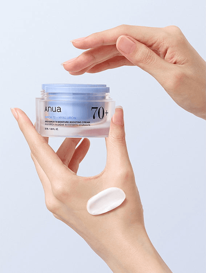 Anua Birch 70 Moisture Boosting Cream in a hand with a cream swatch beside it, promoting hydration for dry skin.