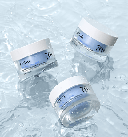 Three jars of Anua Birch 70 Moisture Boosting Cream on water surface, showcasing hydration and skincare benefits.