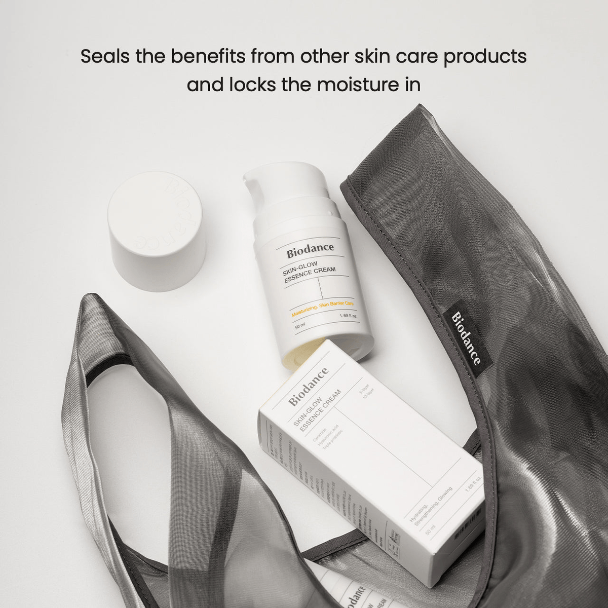 Biodance Skin Glow Essence Cream alongside other skincare products in a stylish bag, highlighting hydration and moisture retention.