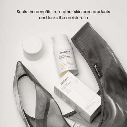 Biodance Skin Glow Essence Cream alongside other skincare products in a stylish bag, highlighting hydration and moisture retention.