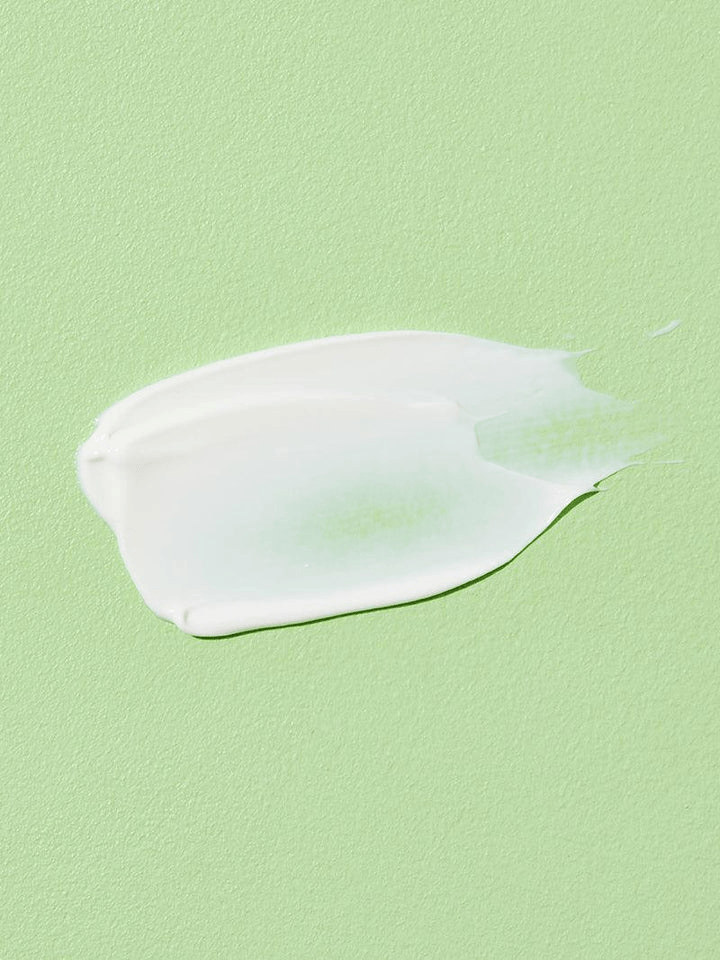 COSRX Aloe Soothing Sun Cream SPF50 creamy application on a green background, ideal for Korean skincare.