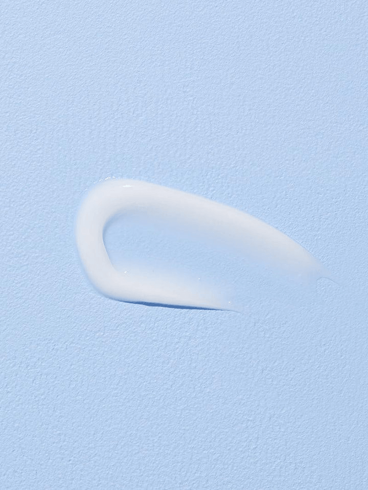 COSRX Hyaluronic Acid Intensive Cream swatch on a light blue background, showcasing its creamy texture.