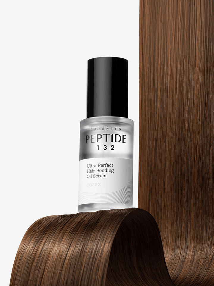 COSRX PEPTIDE-132 Ultra Perfect Hair Bonding Oil Serum bottle on shiny brown hair, showcasing bonding oil benefits, Korean skincare products.