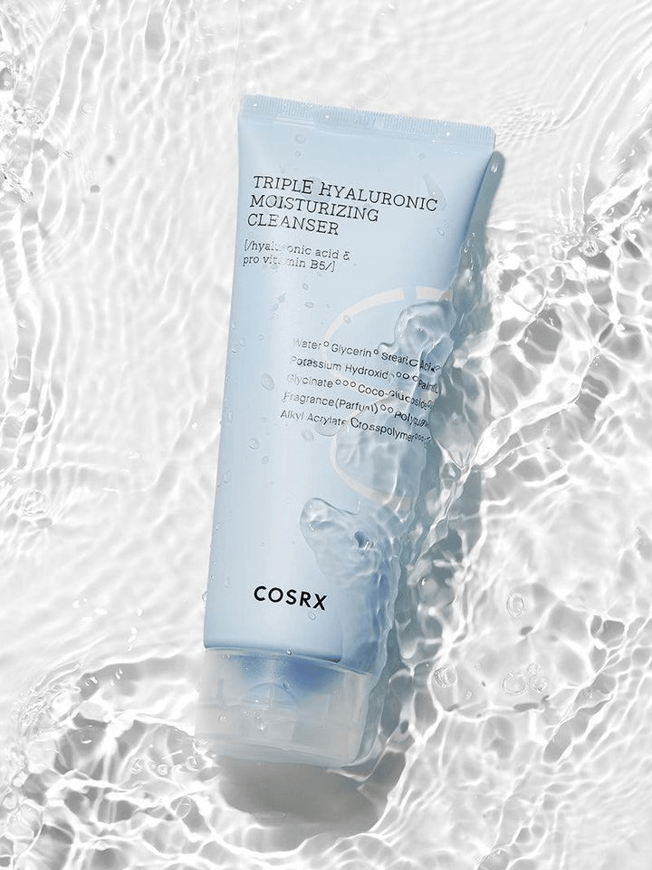COSRX Triple Hyaluronic Moisturizing Cleanser in a soft blue tube with water splash background.
