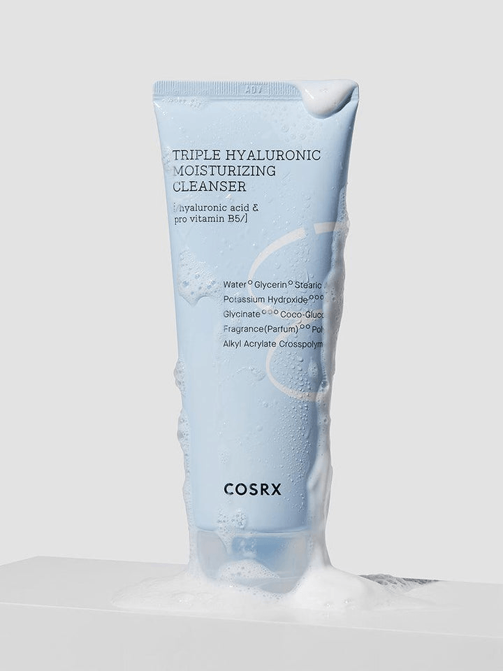 COSRX Triple Hyaluronic Moisturizing Cleanser tube with foam background showcasing hydration benefits.