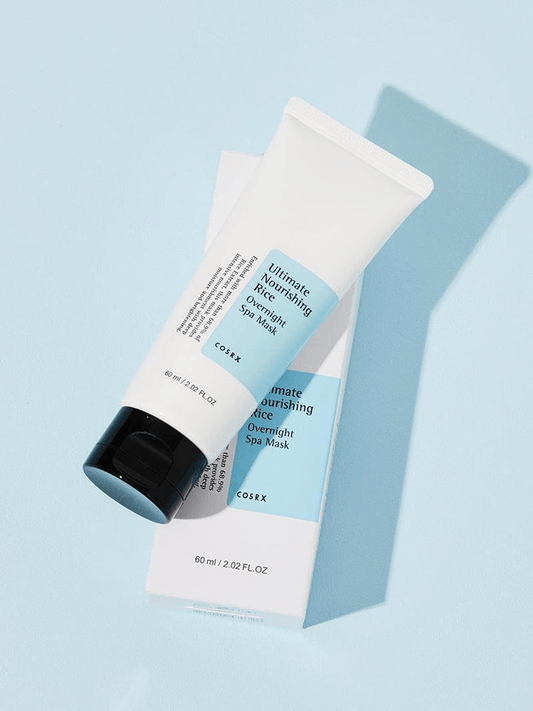COSRX Ultimate Nourishing Rice Overnight Spa Mask in tube with packaging on a blue background.