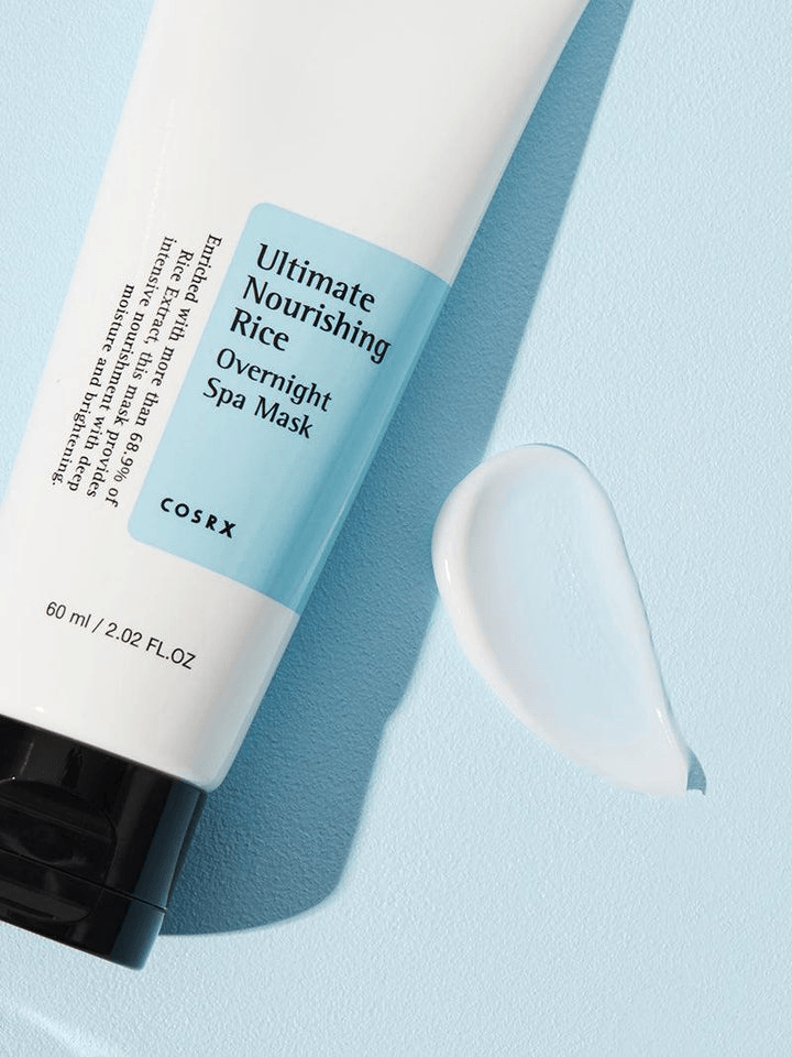 COSRX Ultimate Nourishing Rice Overnight Spa Mask tube with product on a blue background.