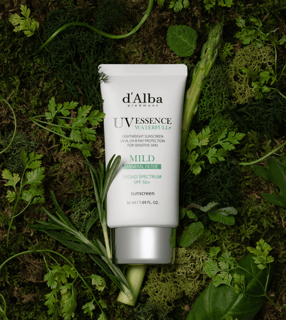 d'Alba White Truffle Waterfull Mild Sunscreen SPF 50 on a bed of green leaves, showcasing its lightweight formulation.