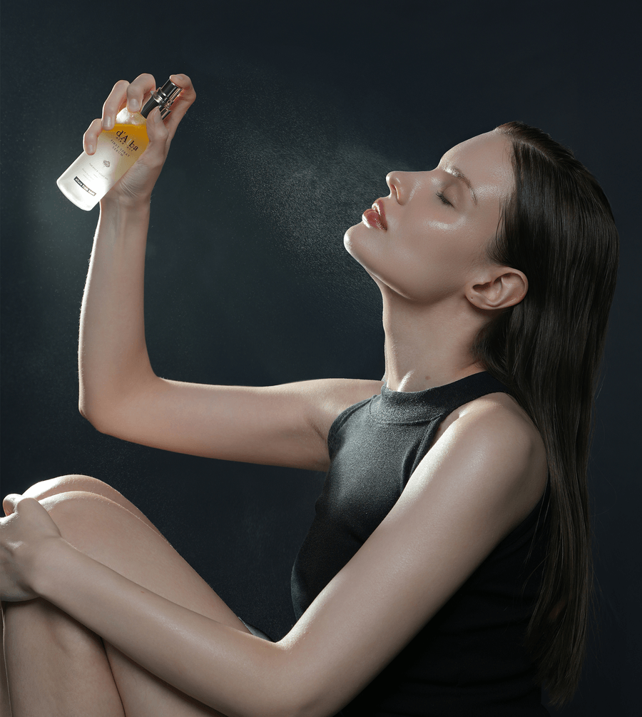 Model using d'Alba White Truffle First Spray Serum, a facial mist for hydration and glow.
