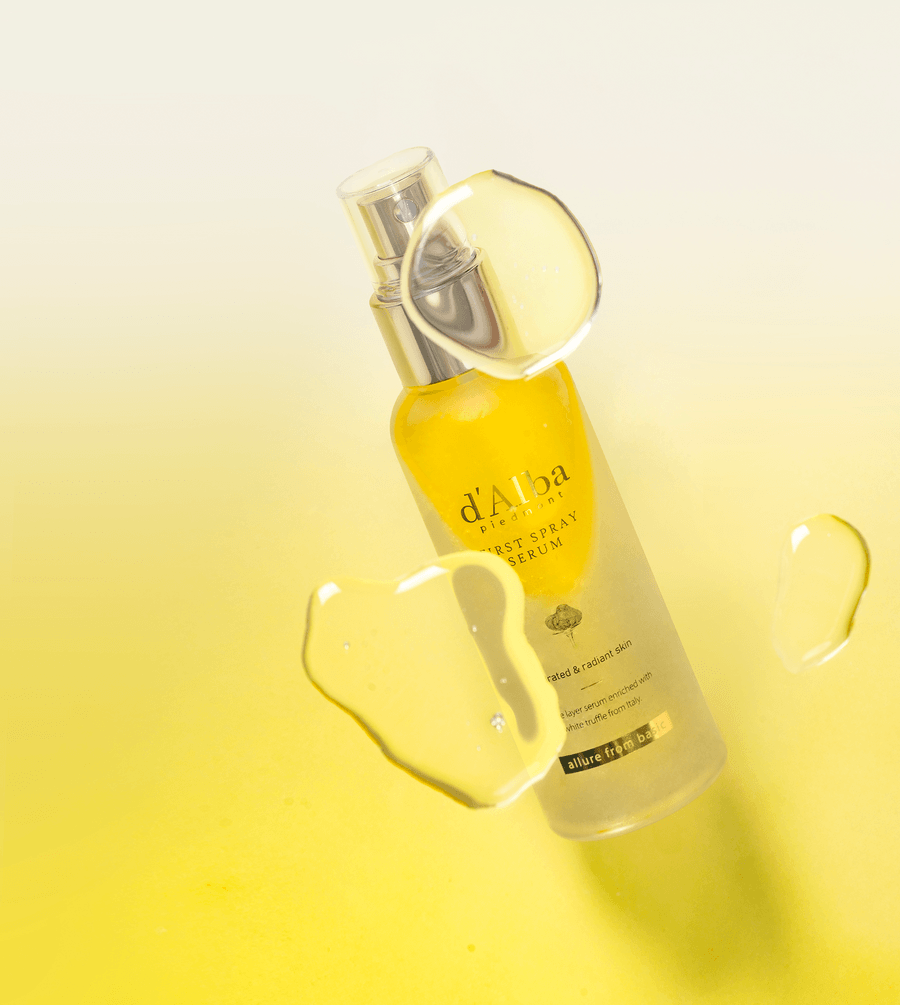 d'Alba White Truffle First Spray Serum in a sleek bottle with yellow accents and moisturizing droplets.