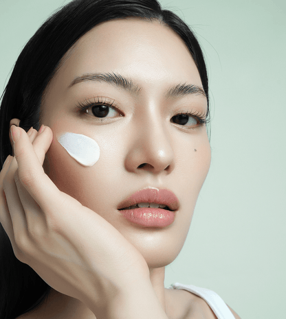 Applying d'Alba White Truffle Waterfull Mild Sunscreen SPF 50 on skin for hydration and UV protection.