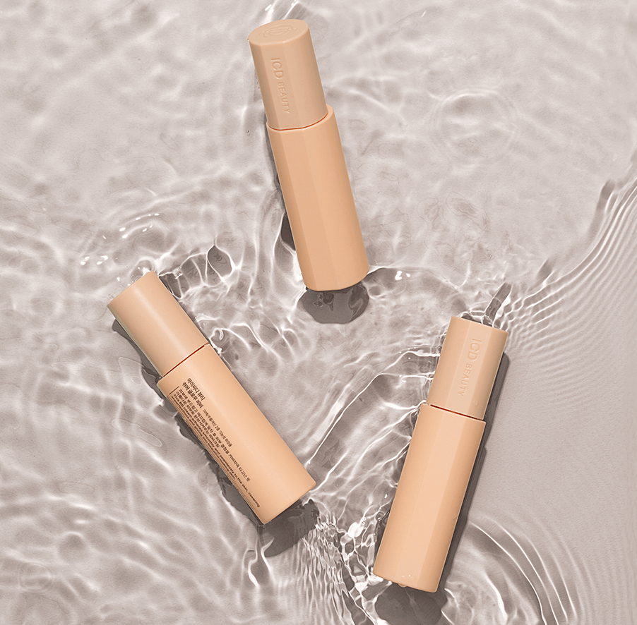 Riman ICD Sheer Glow BB cream bottles on a water surface, highlighting moisturizing and smoothing skin benefits.