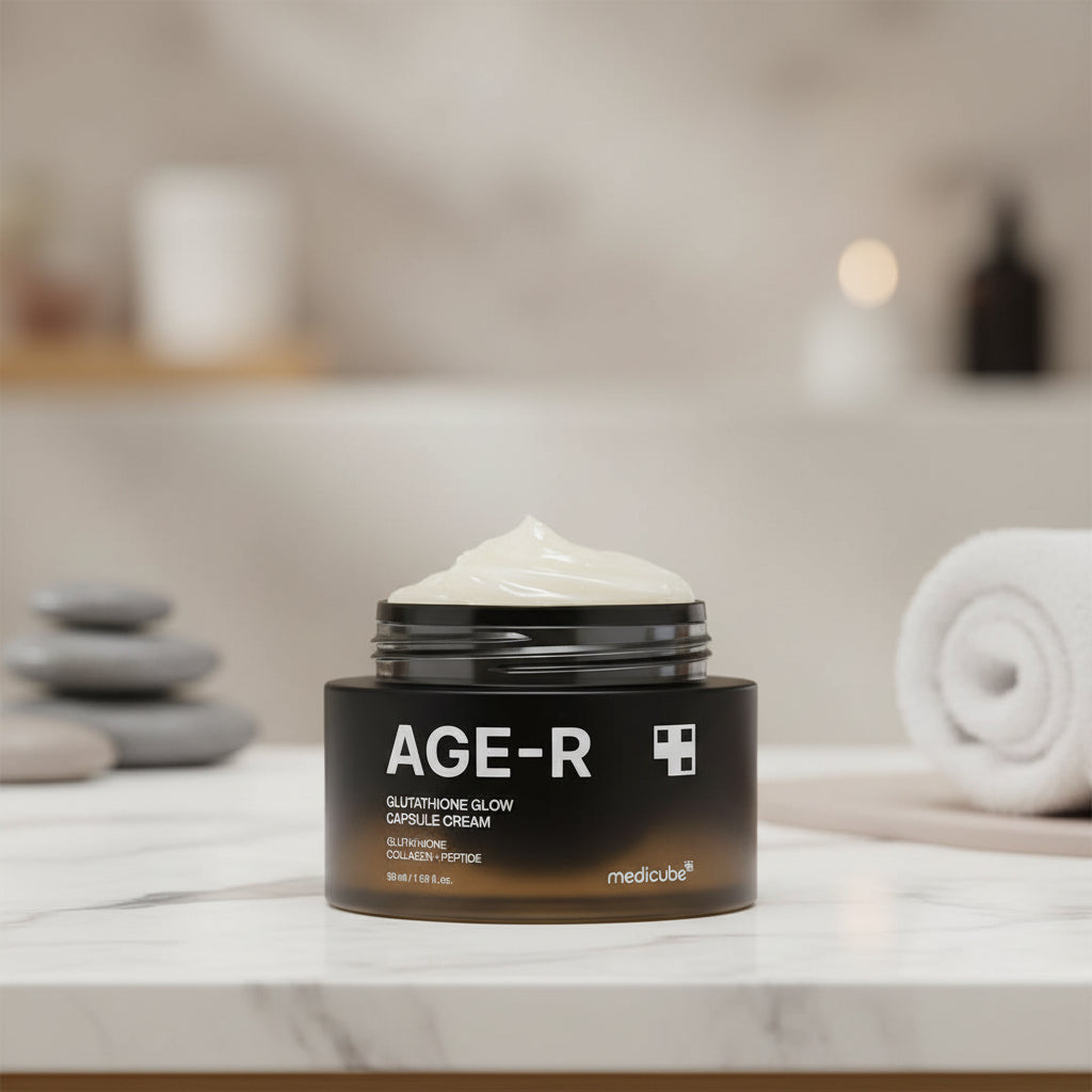 Medicube AGE-R Glutathione Glow Capsule Cream in a sleek black jar, showcasing its creamy texture on a spa-like background.