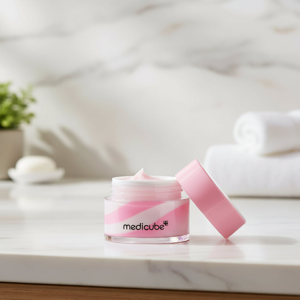 Medicube PDRN Lip Sleeping Mask in a jar with a pink lid on a marble countertop background.
