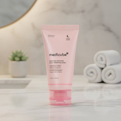 Medicube PDRN Pink Caffeine Overnight Wrapping Mask in pink packaging on a glittery round background.