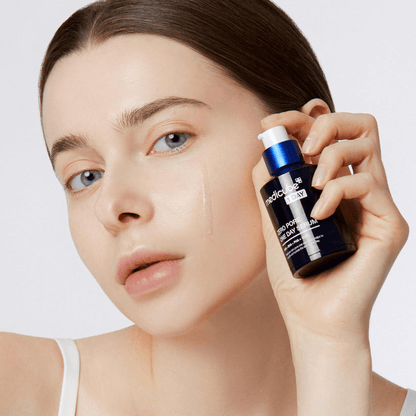 Person holding Medicube Zero Pore One-day Serum, showcasing the bottle with clear skin and visible serum on fingers.