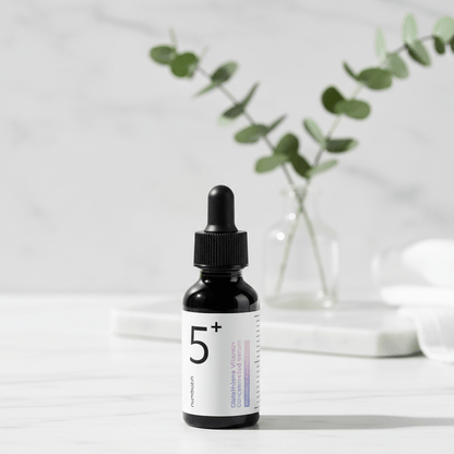 Black dropper bottle with a white label on a white background