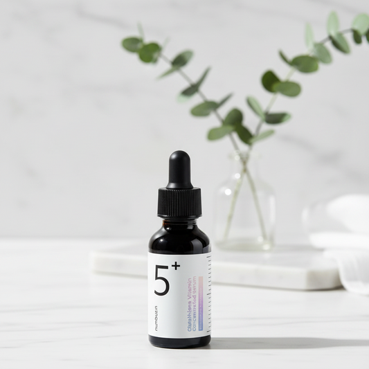 numbuzin No.5 Glutathione Vitamin Concentrated Serum bottle on a marble surface with greenery in the background