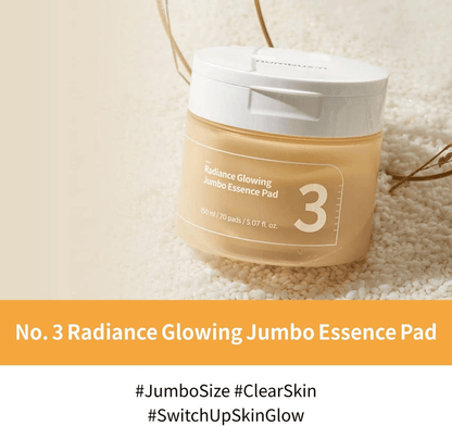 numbuzin No.3 Radiance Glowing Jumbo Essence Pads in a jar on a textured background, promoting skin hydration and glow.
