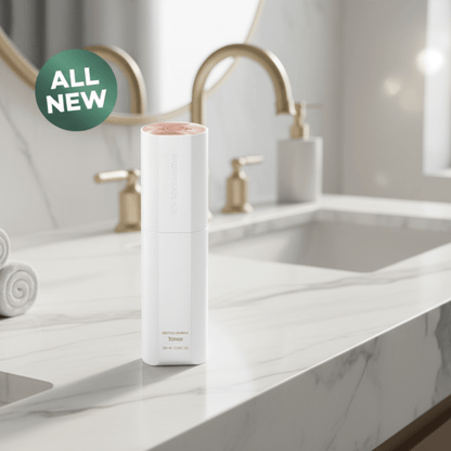 ICD Radiansome 100 Microfluidizer Toner bottle shown on a bathroom counter with a golden faucet and a green 'All New' badge.