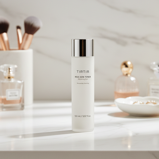 TIRTIR Milk Skin Toner | Korean Skincare Products displayed on a marble surface with towels and plants.